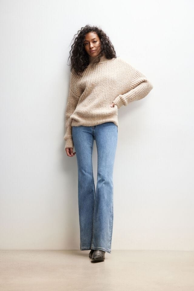 model wearing the jeans with a sweater