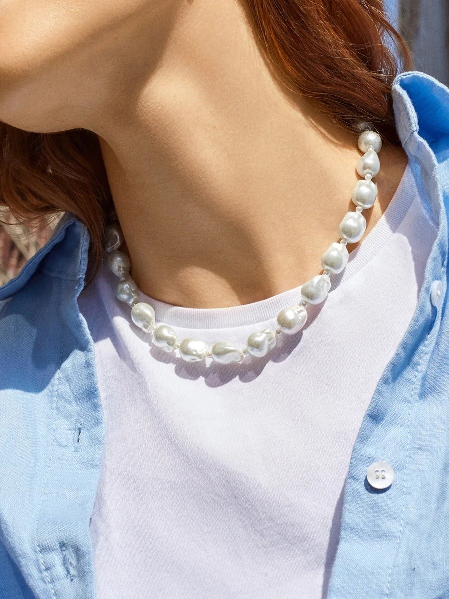 model wearing pearl necklace