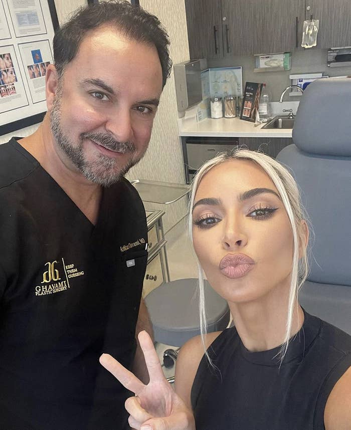 Kim Kardashian posing with her plastic surgeon