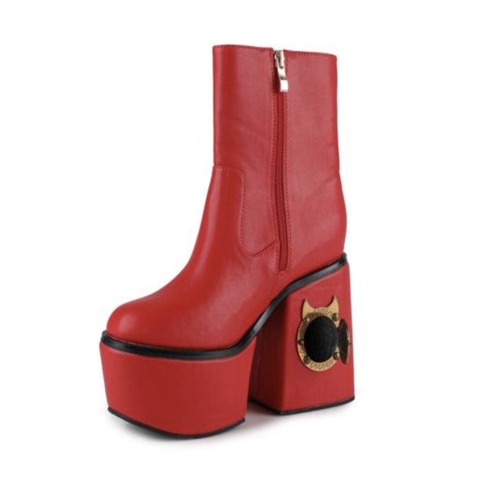 A red platform boot with a little opening in the heel