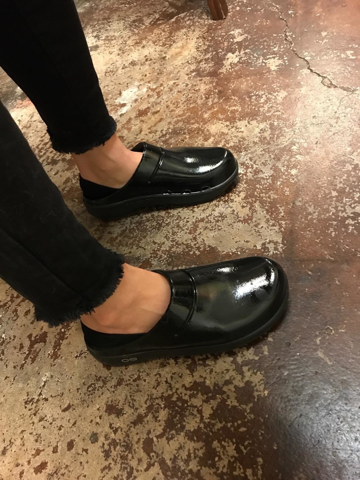 Reviewer in the shiny black clogs