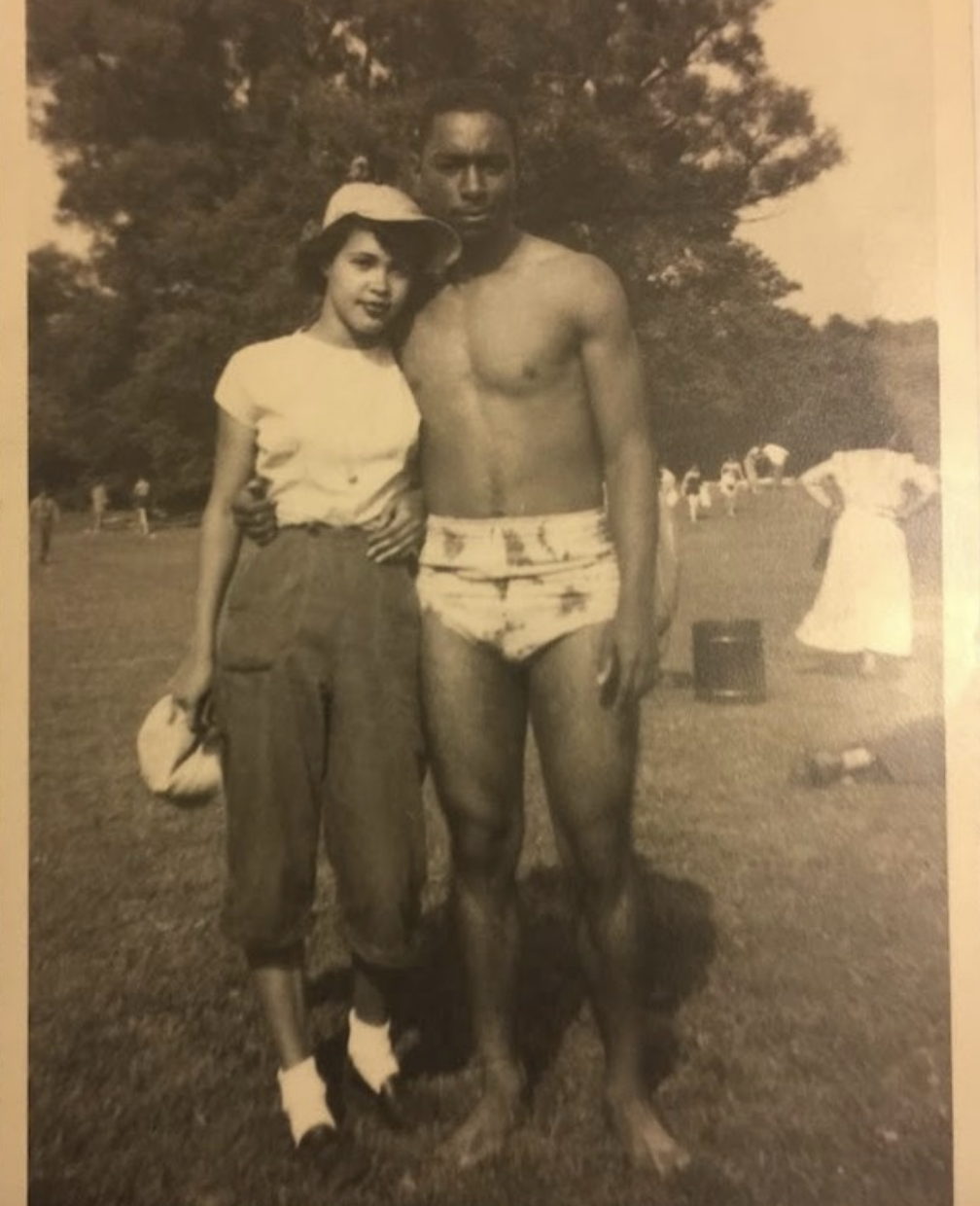 Two young people outside long ago