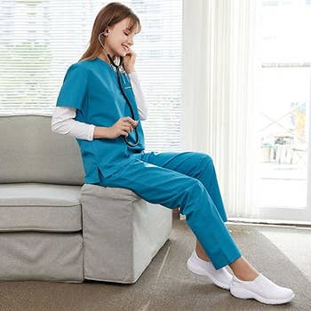 nurse sitting down and practicing with stethoscope in the white shoes