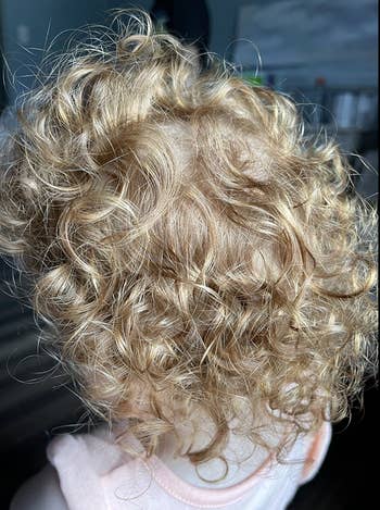 the same reviewer's child with the curls looking less frizzy and better defined
