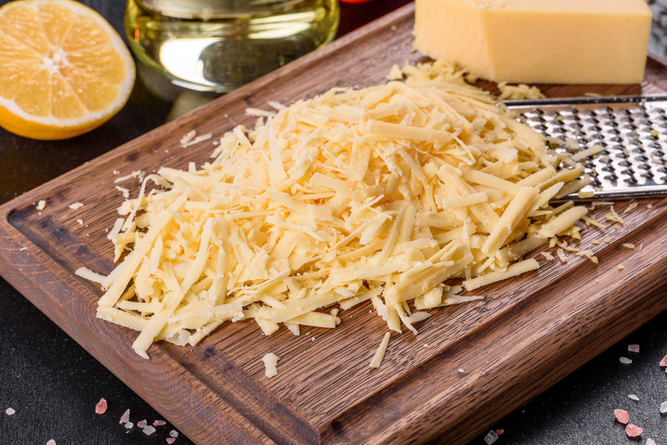 Shredded cheese on cutting board