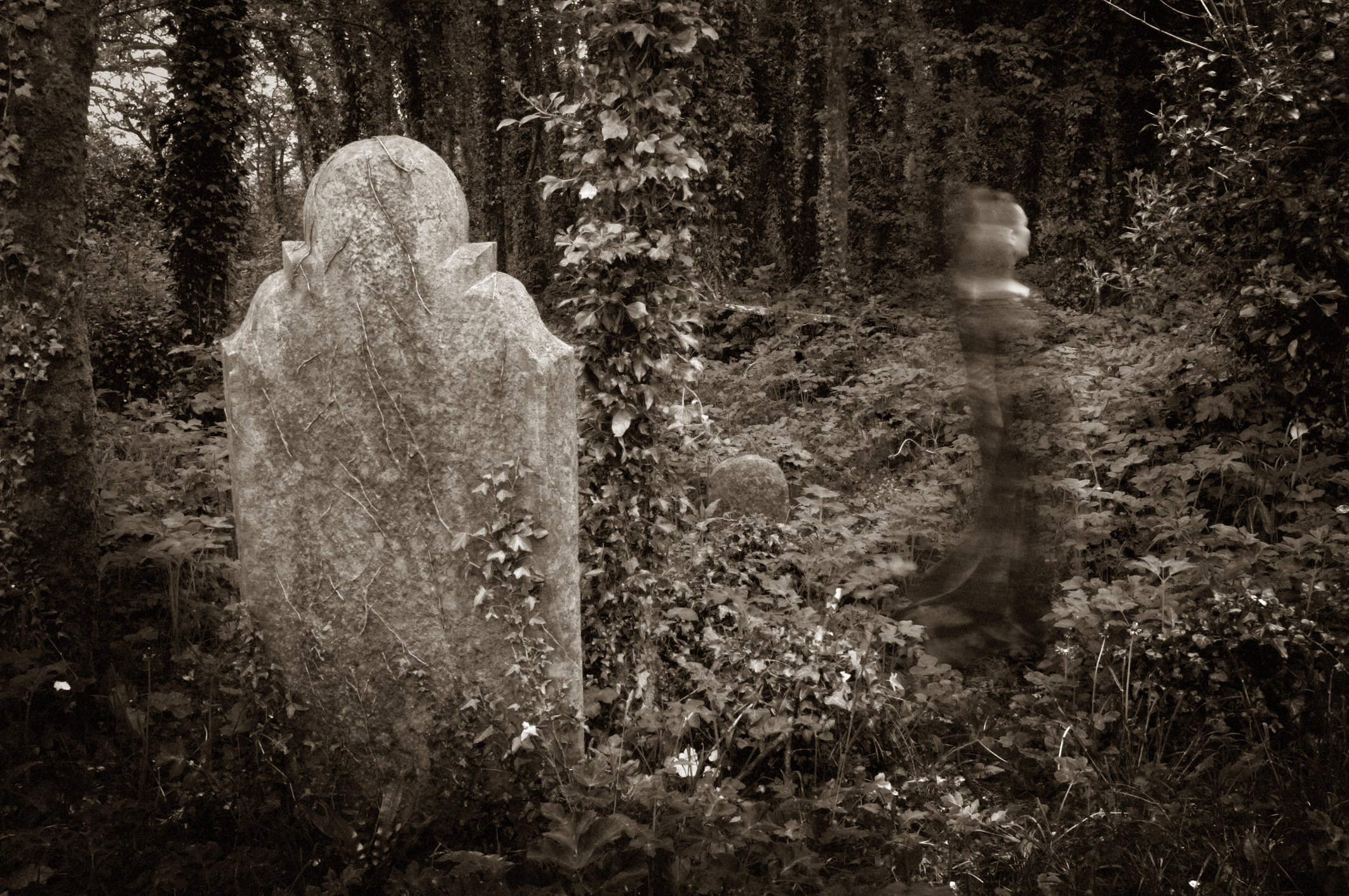 a ghost moving through a graveyard