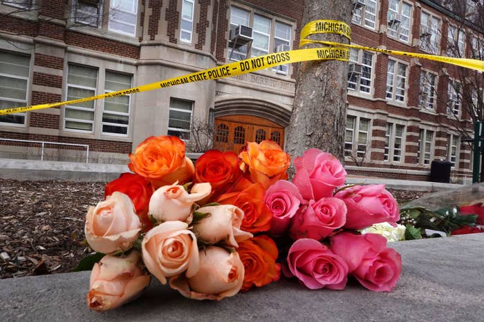 Flowers and crime scene tape outside Berkey Hall on the campus of Michigan State University