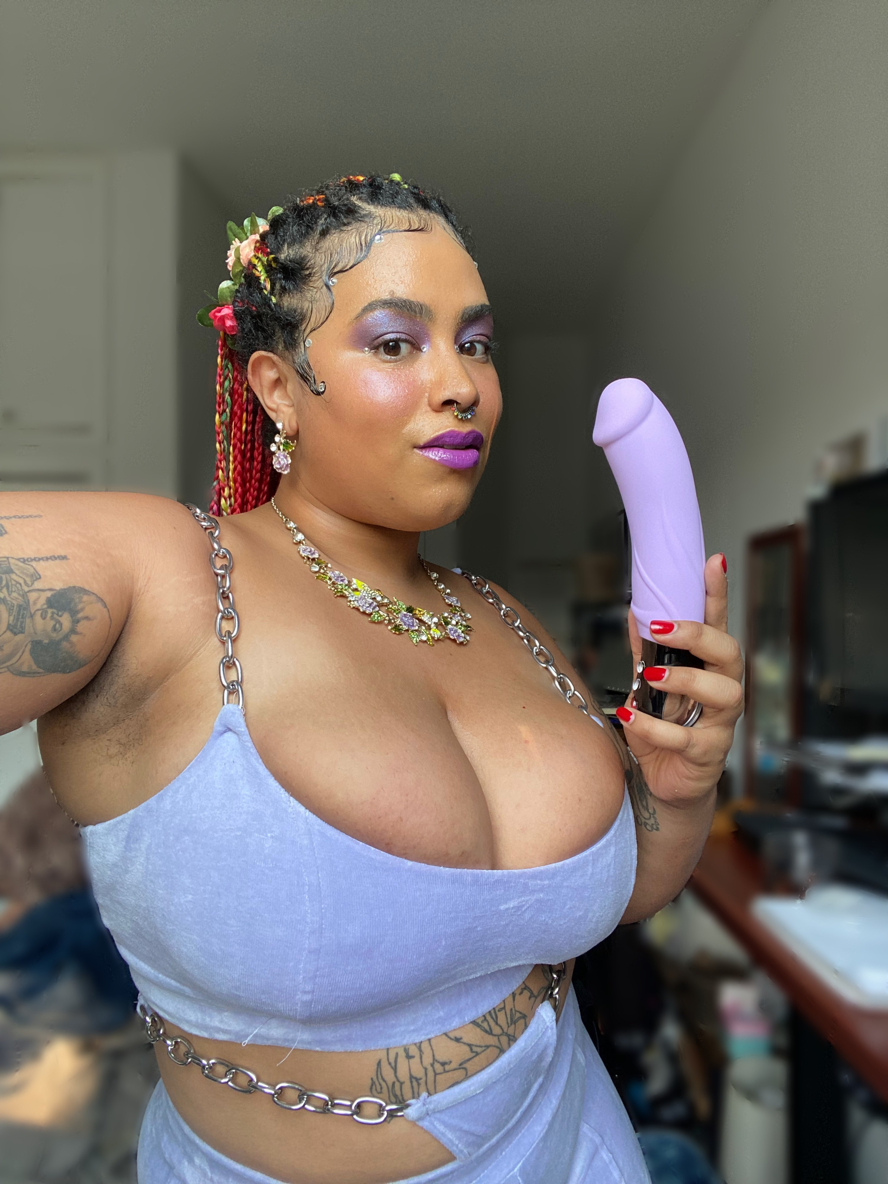 Woman holding purple vibrating dildo