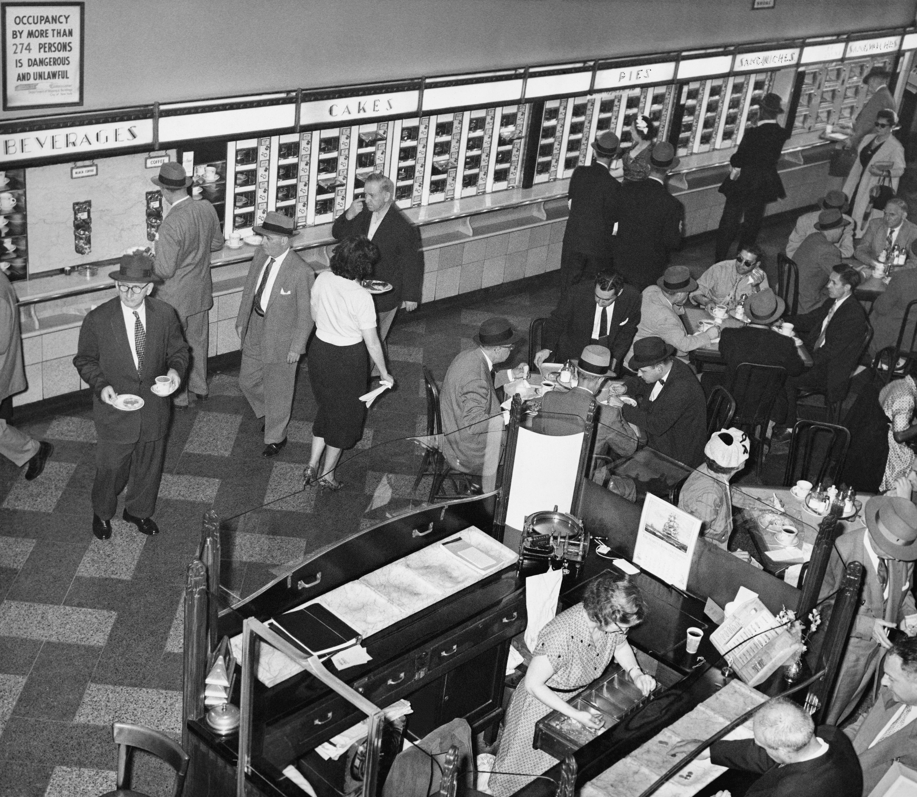 A man ordering a pie at a Horn &amp; Hardart’s Automat