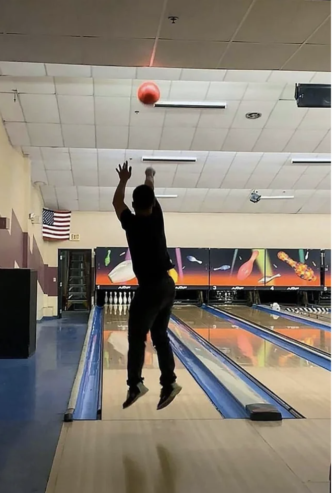 Someone throwing a bowling ball.