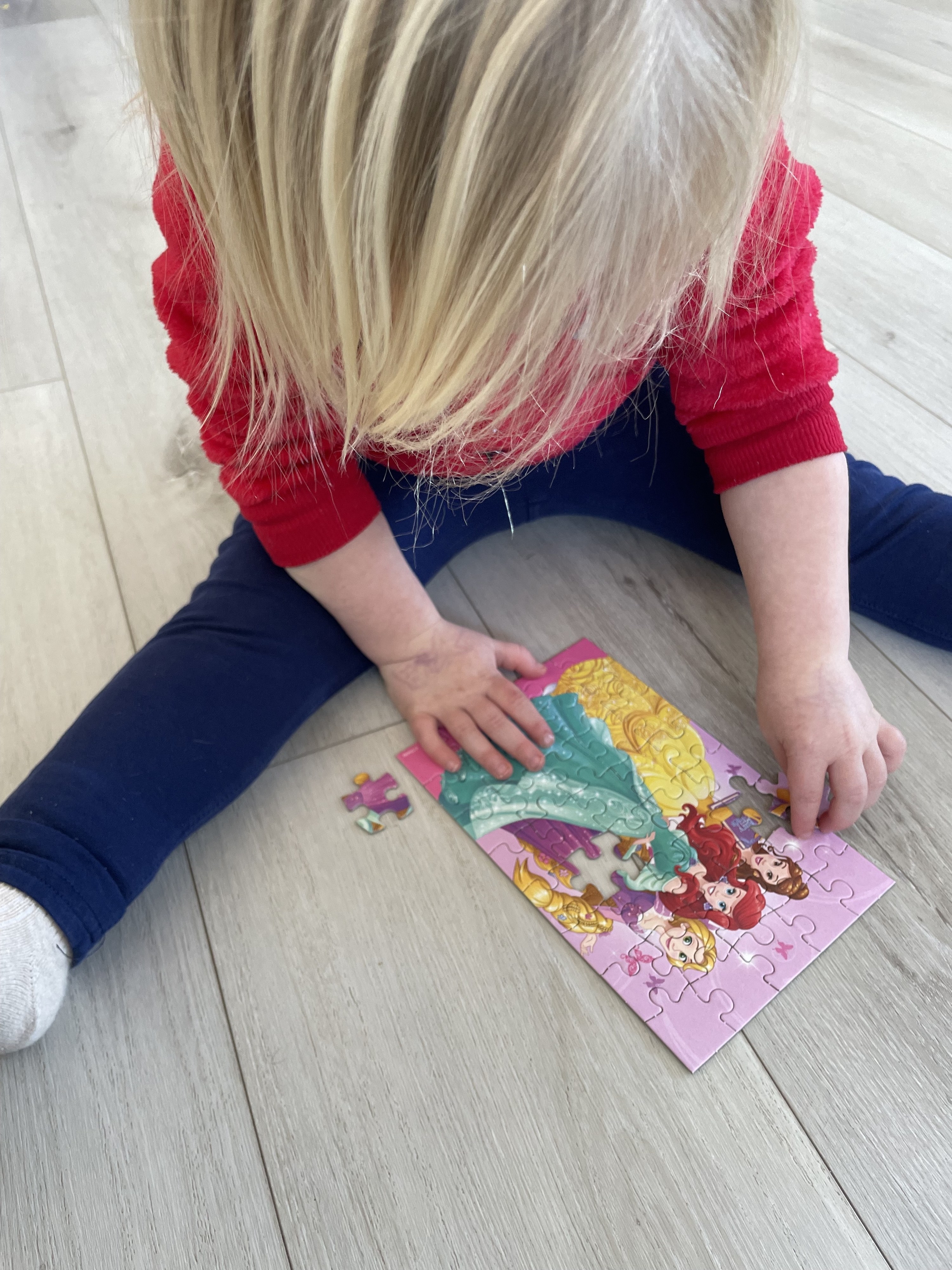 the author&#x27;s daughter putting together a puzzle