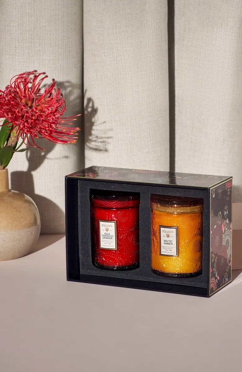 A frosty candle red and orange candle with a flower