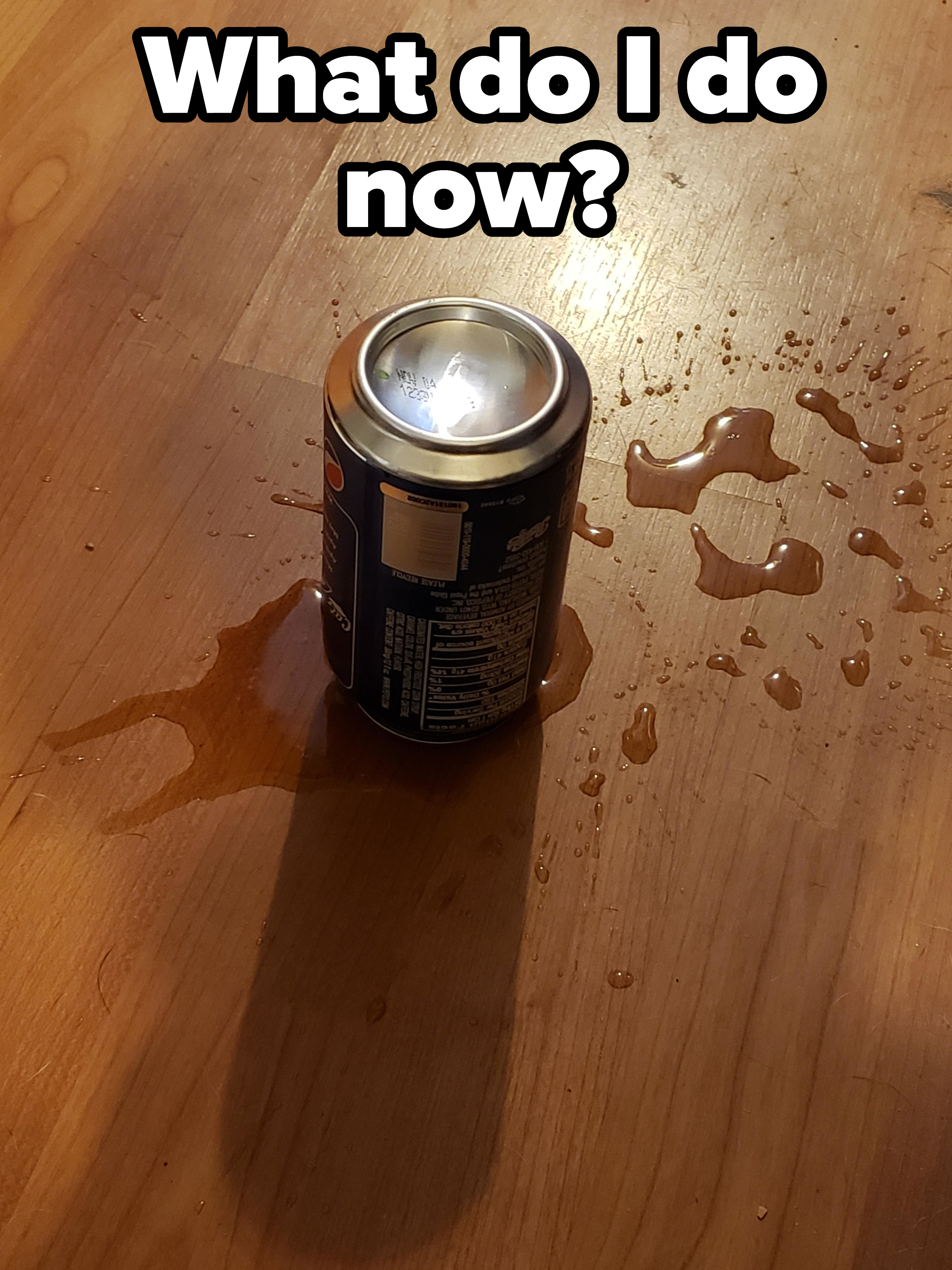 Upside-down Pepsi can that fell on the floor, with only some of it on the floor