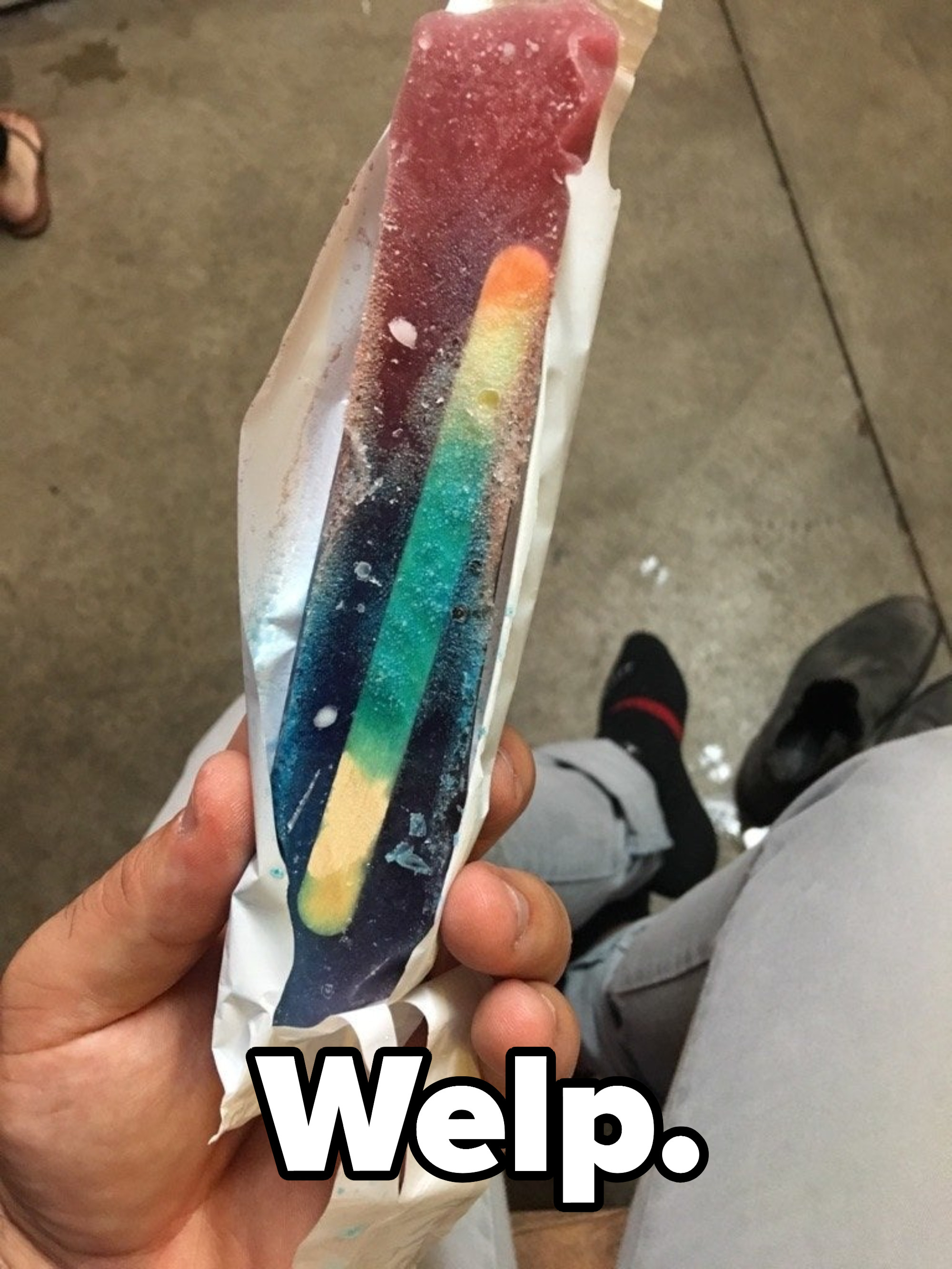 Stick inside a multicolored frozen ice pop