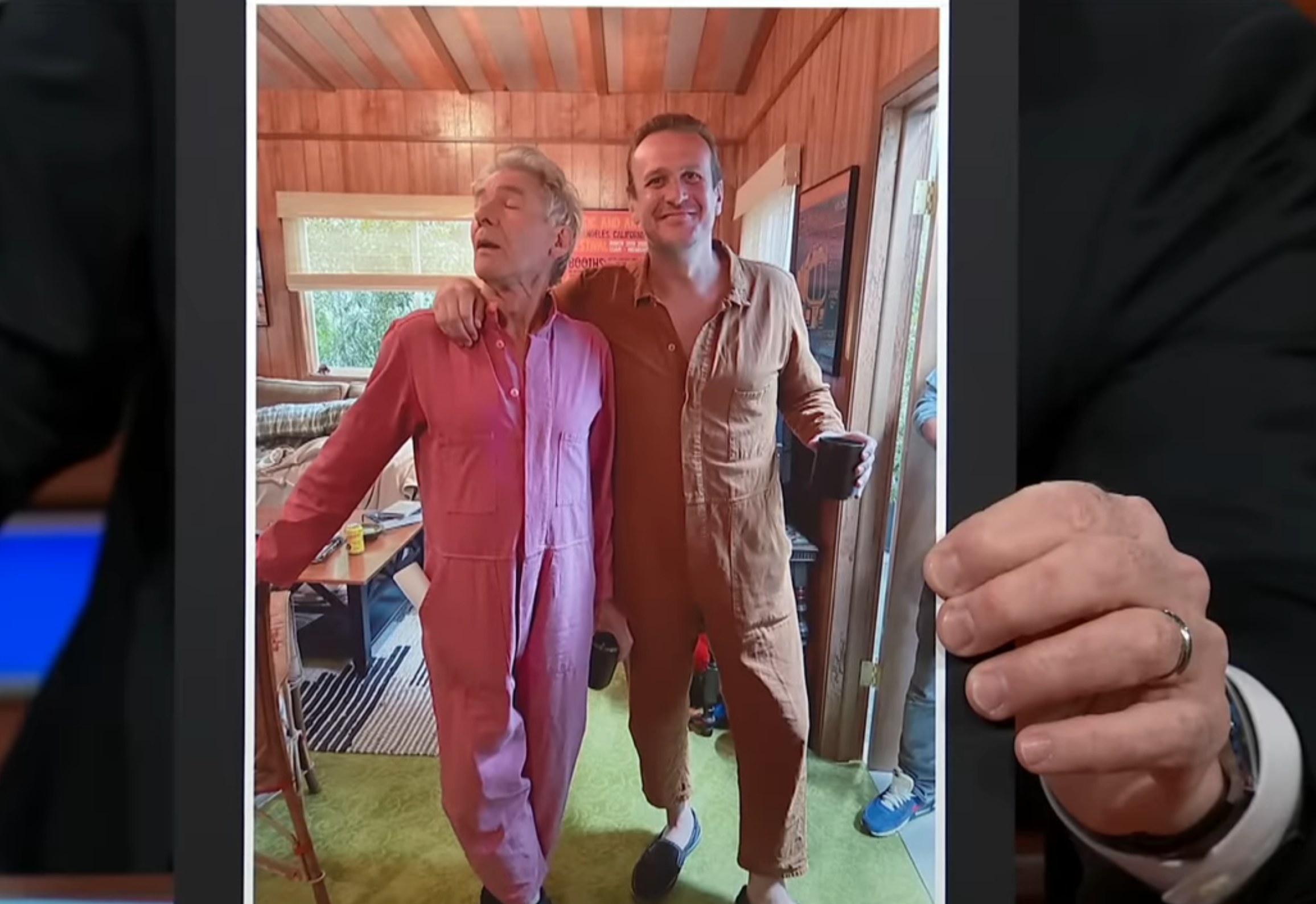 Stephen Colbert shows a photo of Harrison Ford and Jason Segel wearing jumpsuits together behind the scenes of &quot;Shrinking&quot;