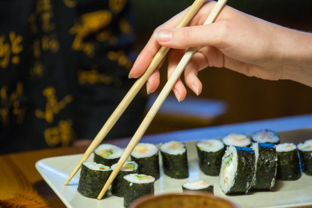 chopsticks grabbing sushi