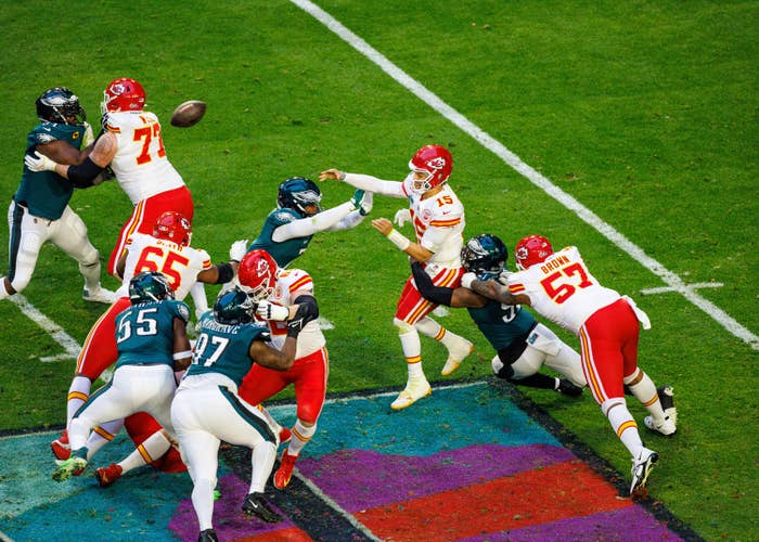 Patrick Mahomes throws a pass under pressure during Super Bowl LVII