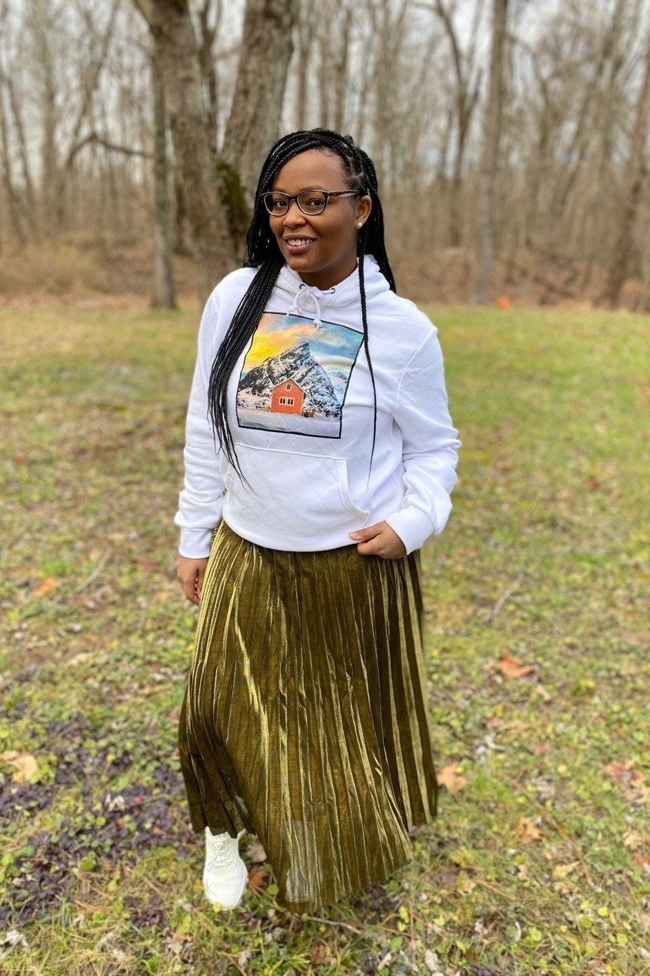 reviewer looking fabulous wearing gold metallic pleated skirt with sneakers and hoodie