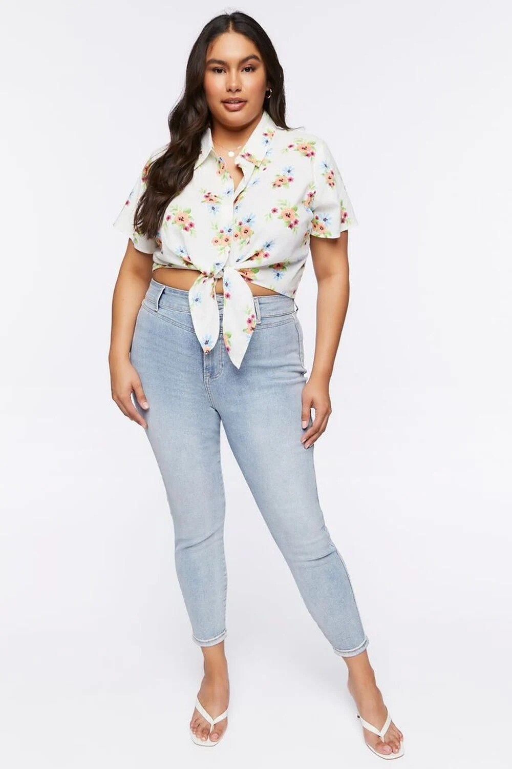 a plus size model wearing a floral cropped front tie shirt