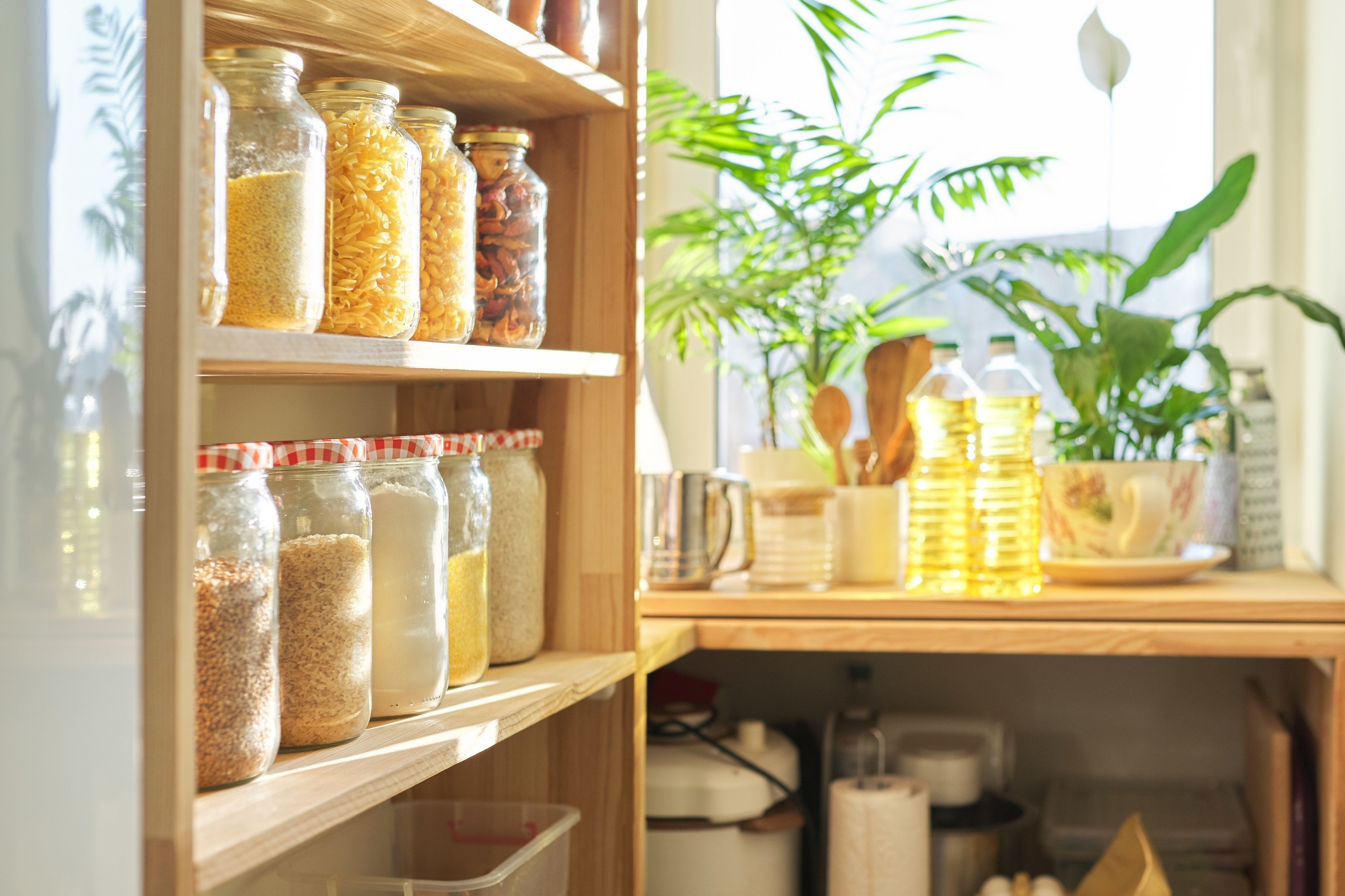 Pantry shelves stocked with food storage jars