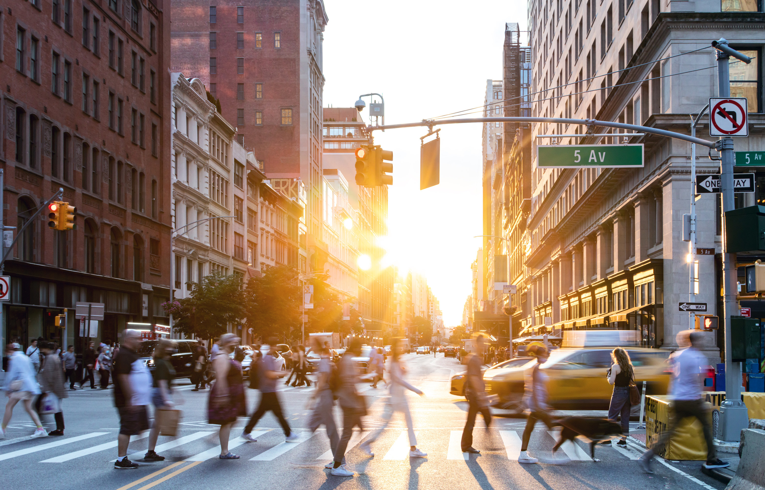 people walking across 5th Ave in New York