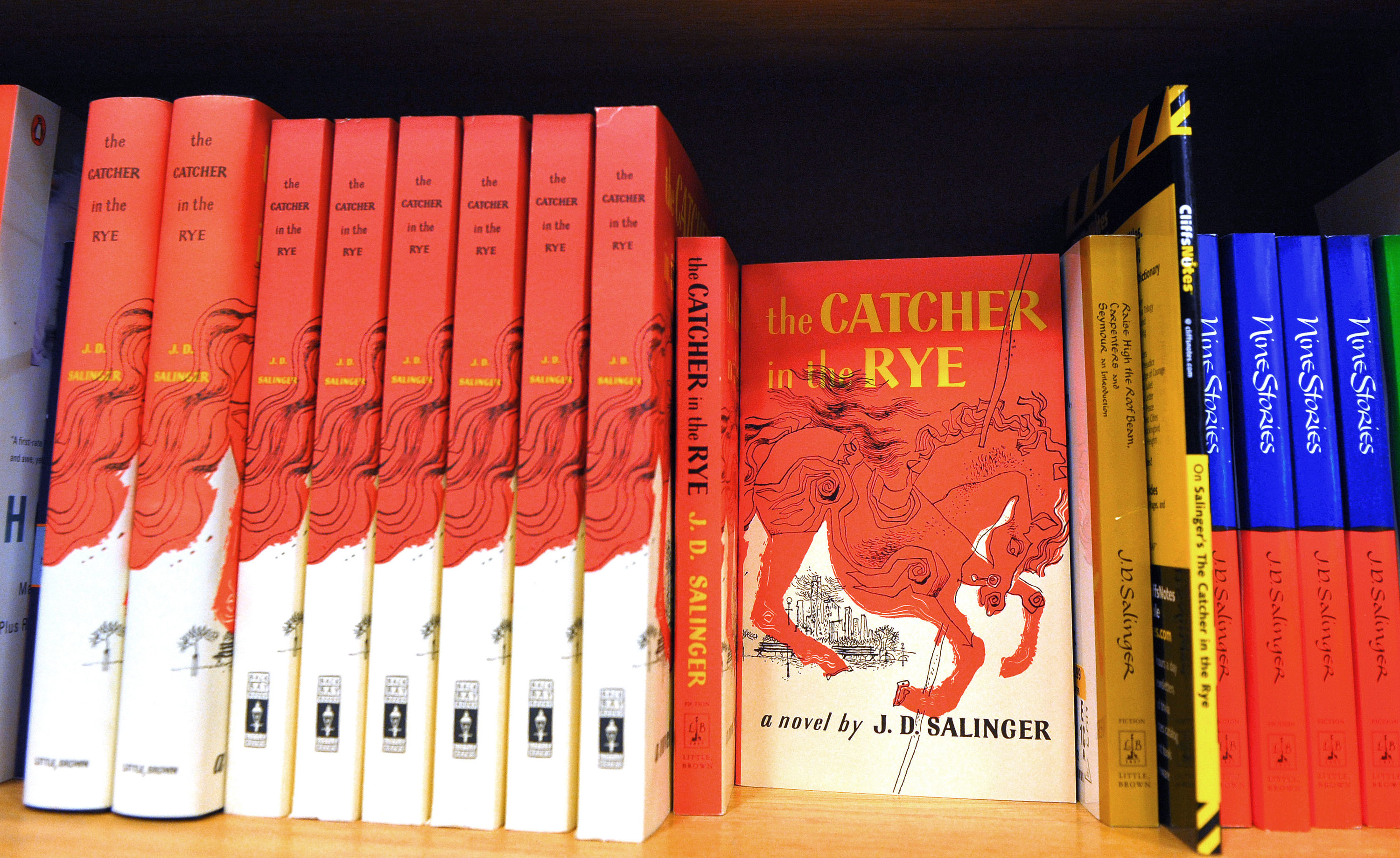 Copies of The Catcher in the Rye on a bookshelf