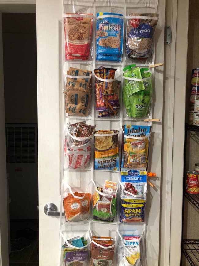 reviewer showing organizer hanging on pantry door holding various items