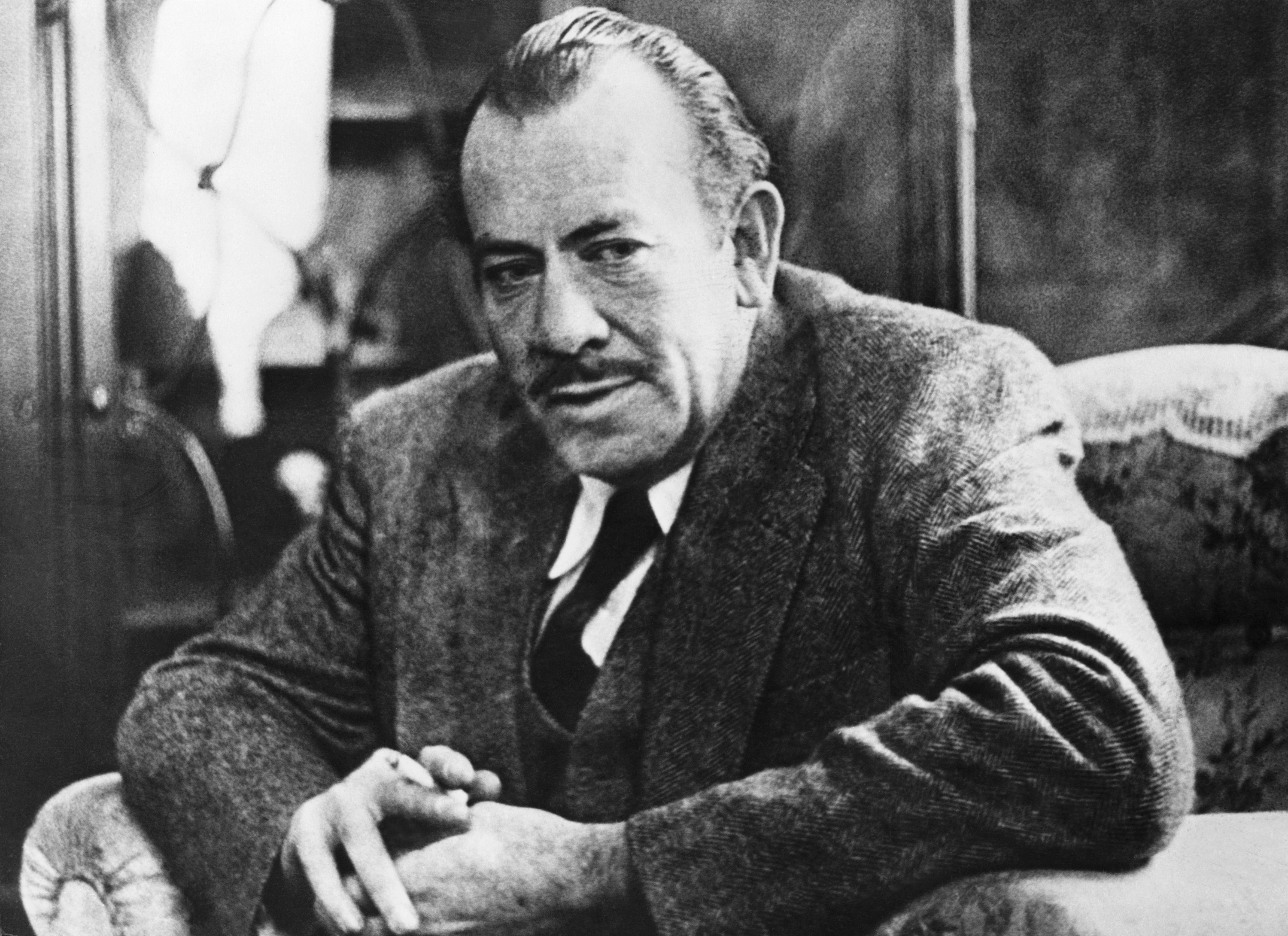 John Steinbeck sitting with his hands together