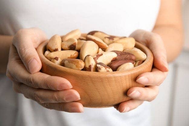 Person holding a bowl of nuts