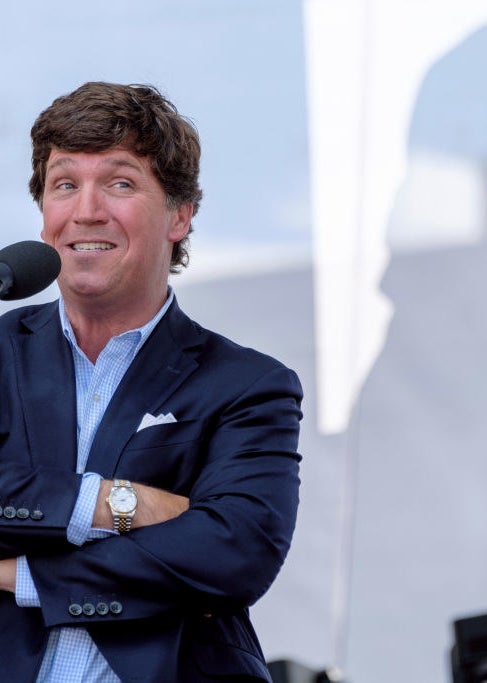 Tucker talking into a mic