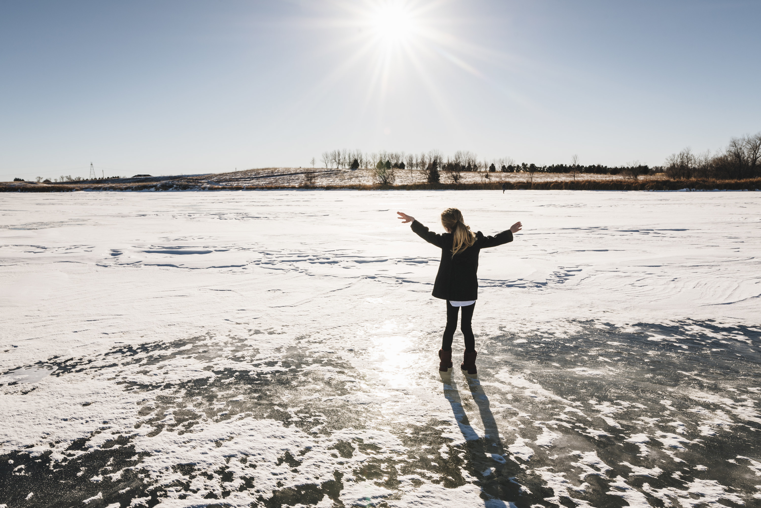 child standing on a frozen lake