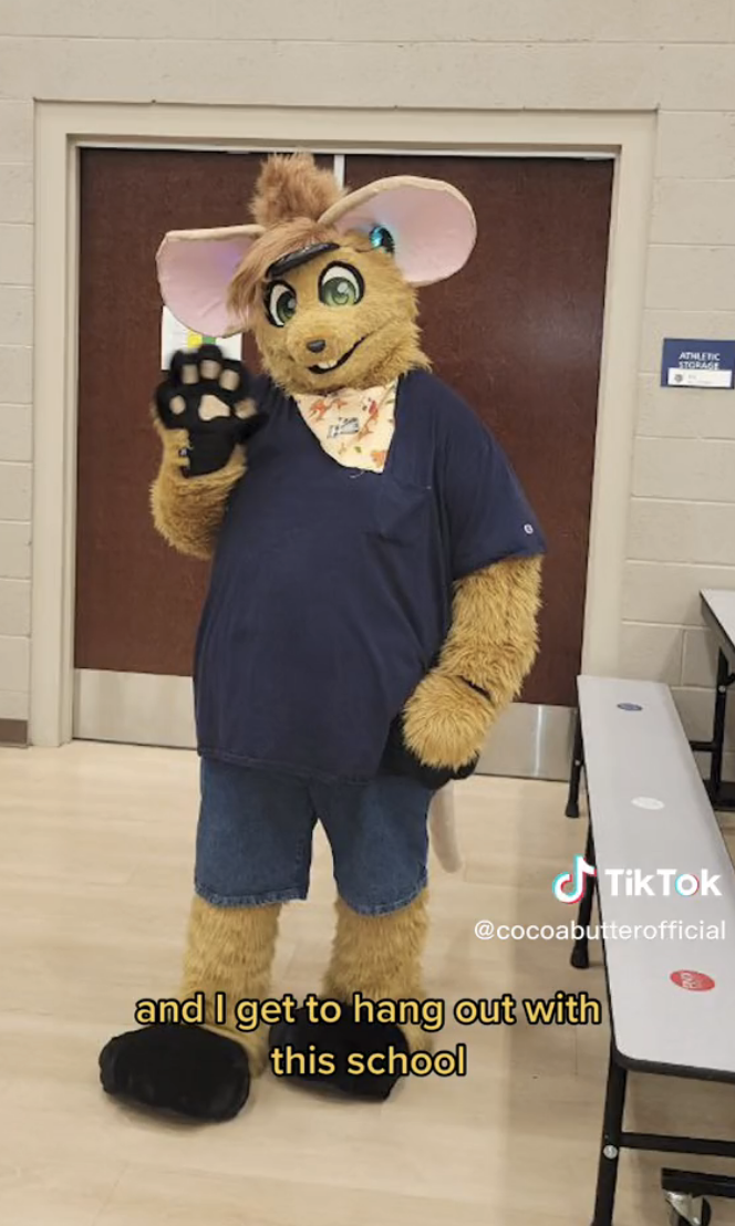Lamar dressed as Gibson the Mouse at a school
