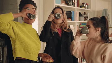 three girls taking an espresso shot and then making a face like it&#x27;s really strong