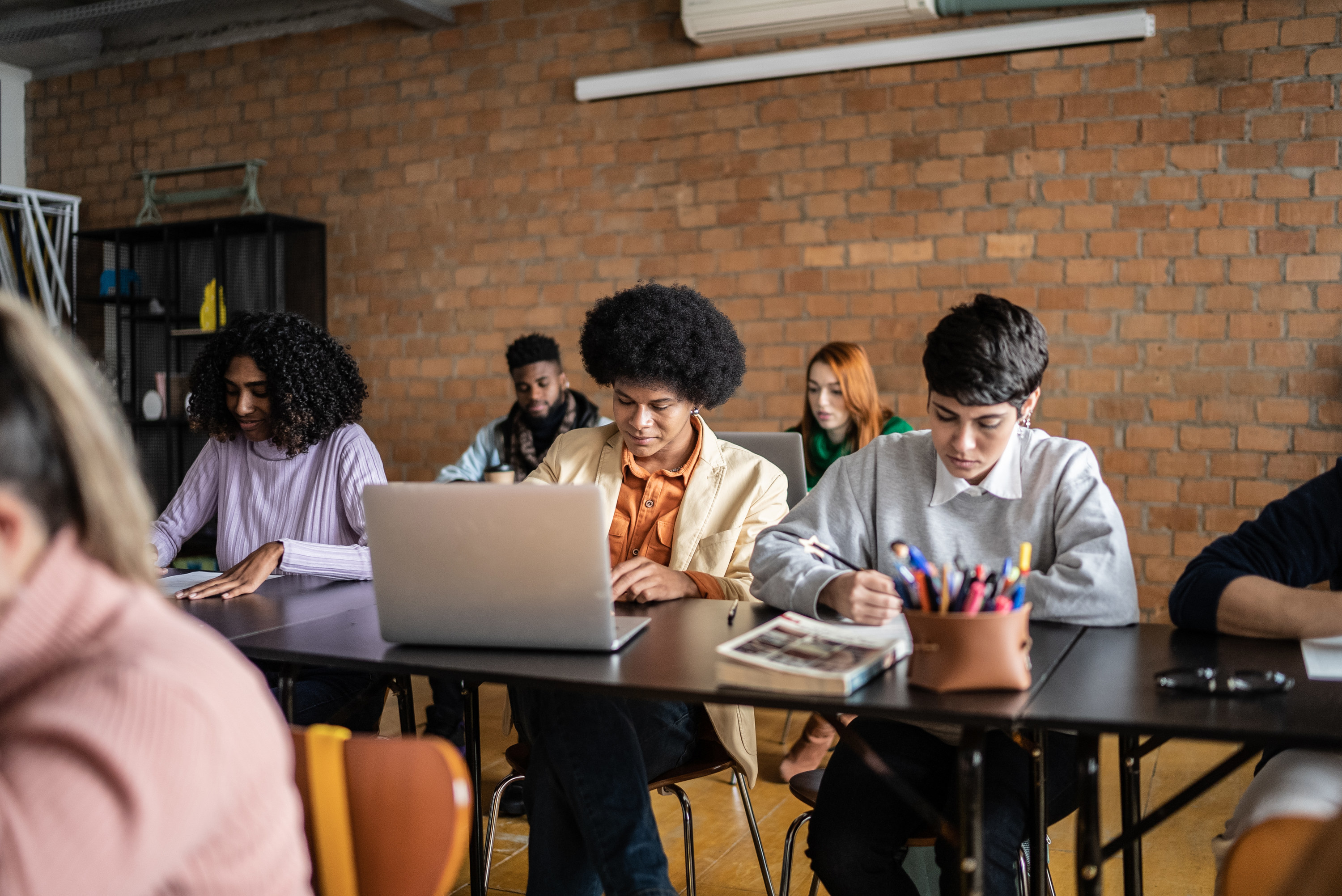 students sitting in class taking notes