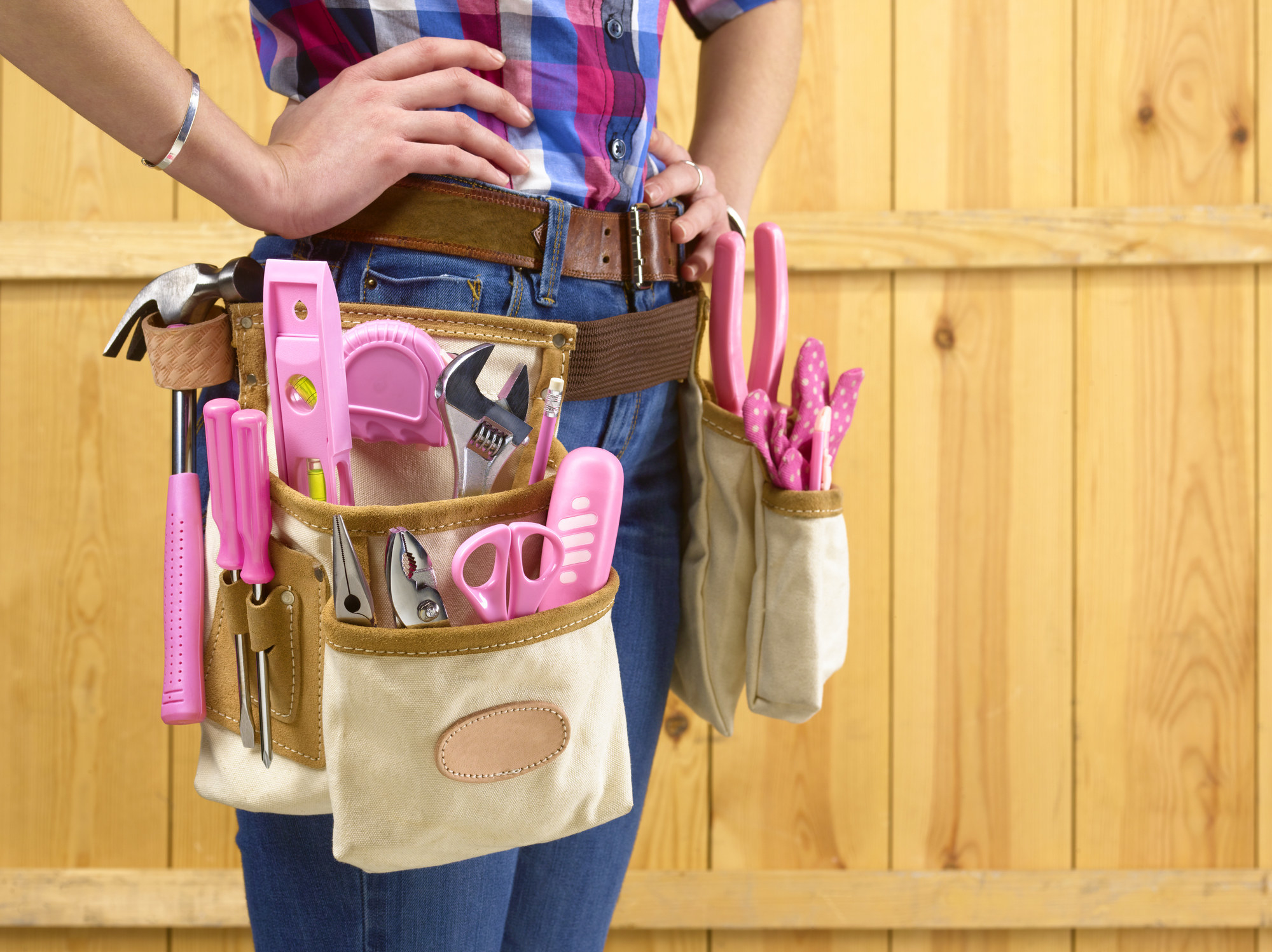A tool belt with pink tools around a person&#x27;s waist