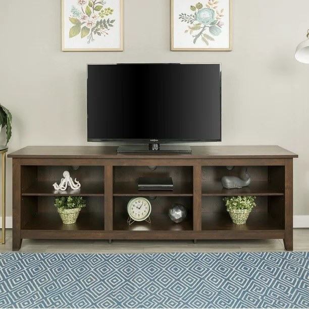 The tv stand in front of an area rug