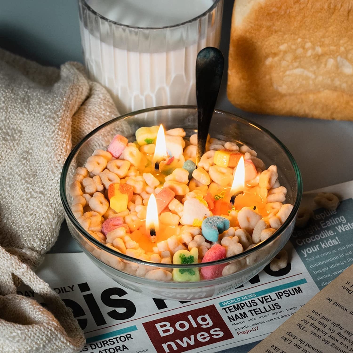 The cereal bowl candle on a newspaper