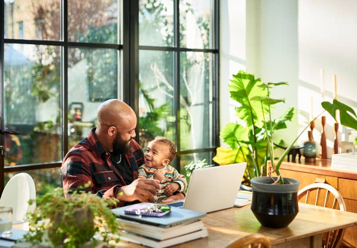 a dad hanging with his baby at the desk