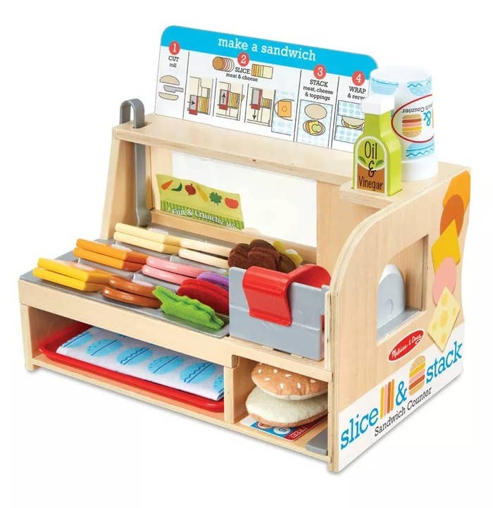 Wooden deli counter toy with colorful pieces of food