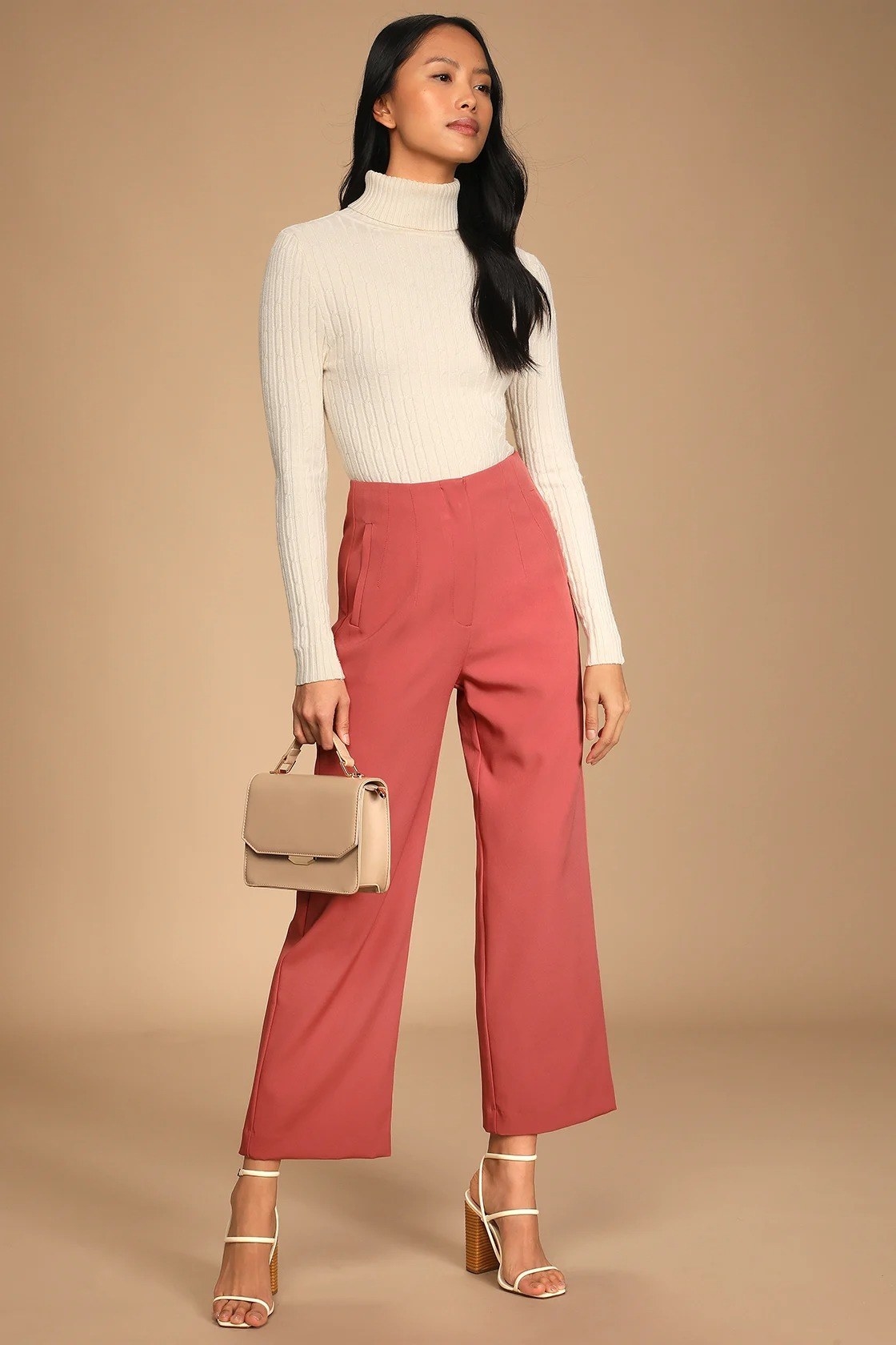 model wearing the trousers in mauve with a white top