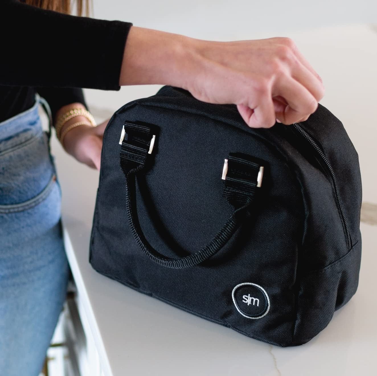 person unzipping the lunch bag
