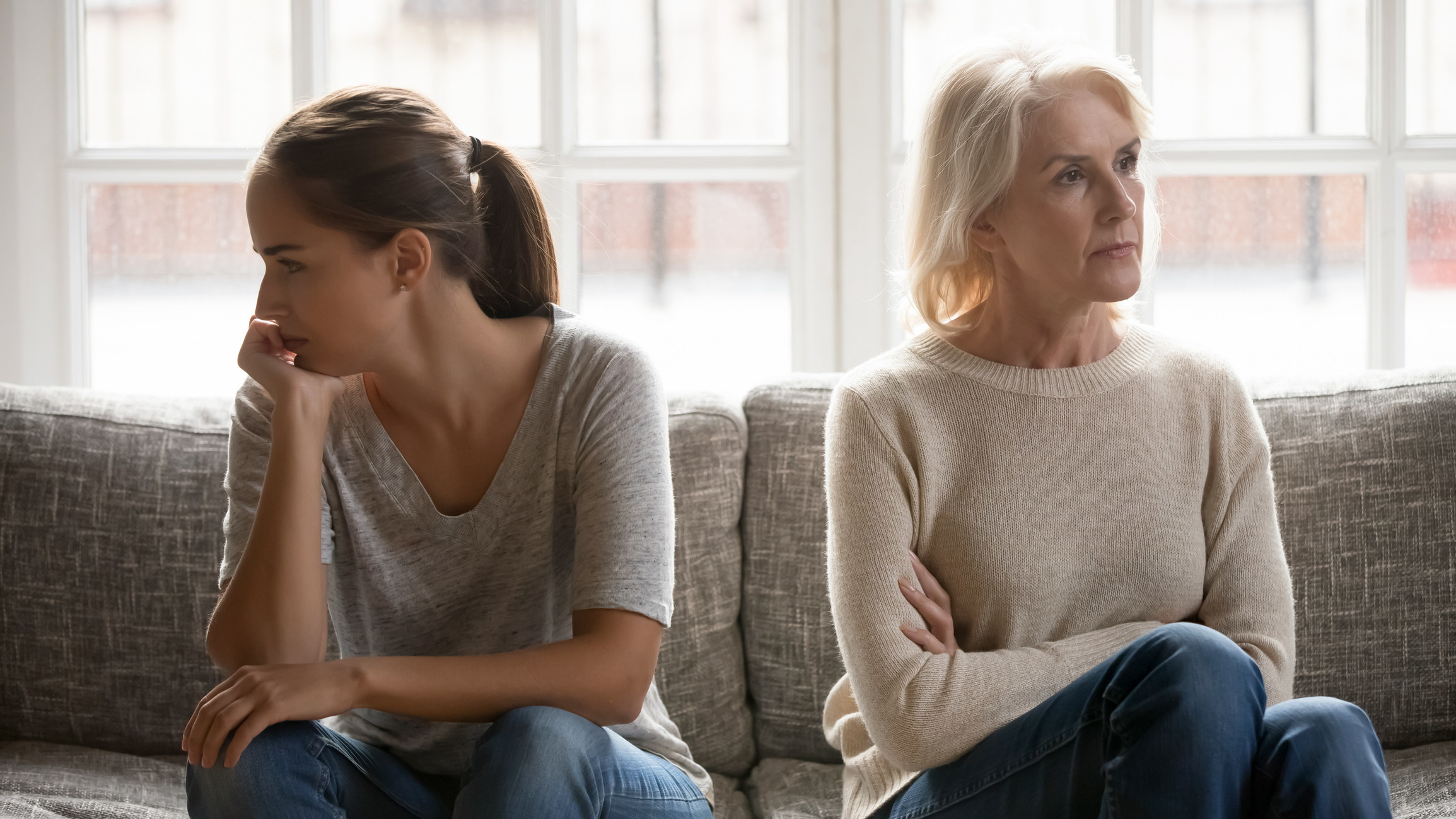 A mother and daughter avoiding eye contact