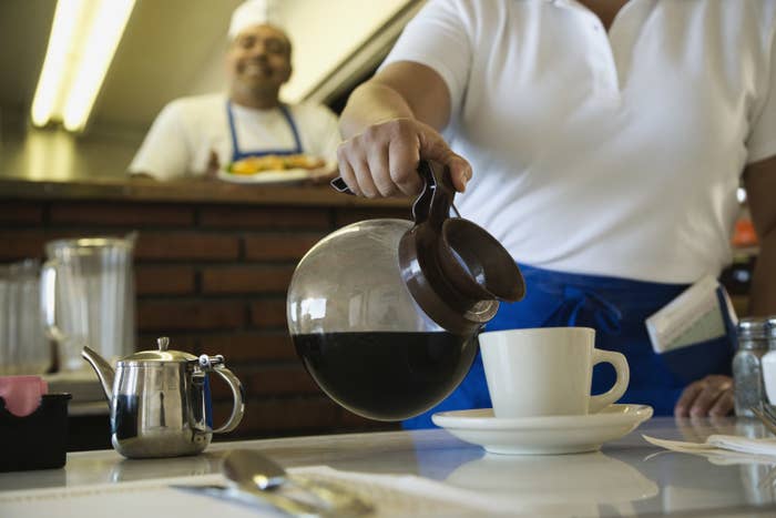 a waitress pouring coffee in a diner