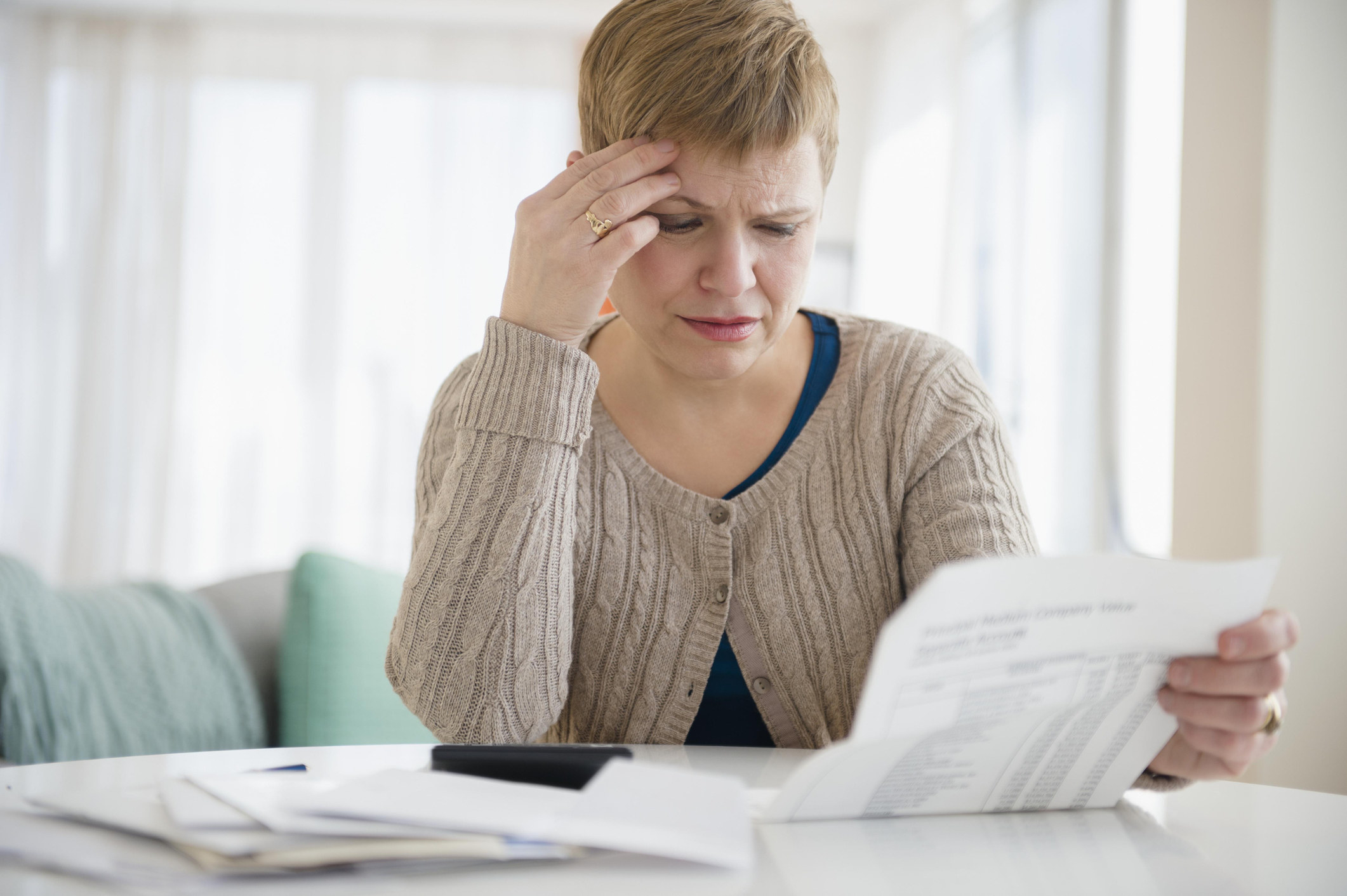 A woman looking at her bills