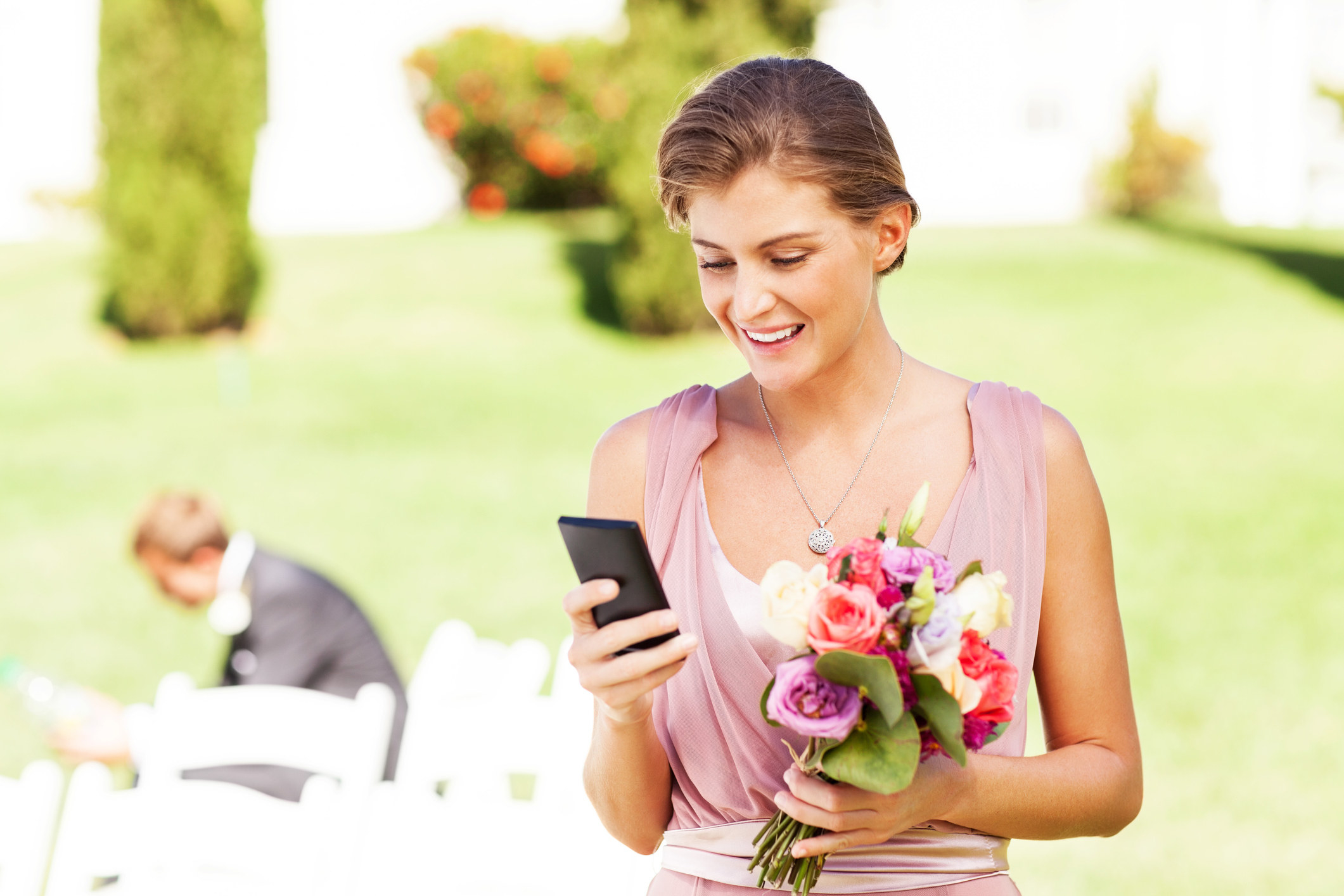 A bridesmaid texting