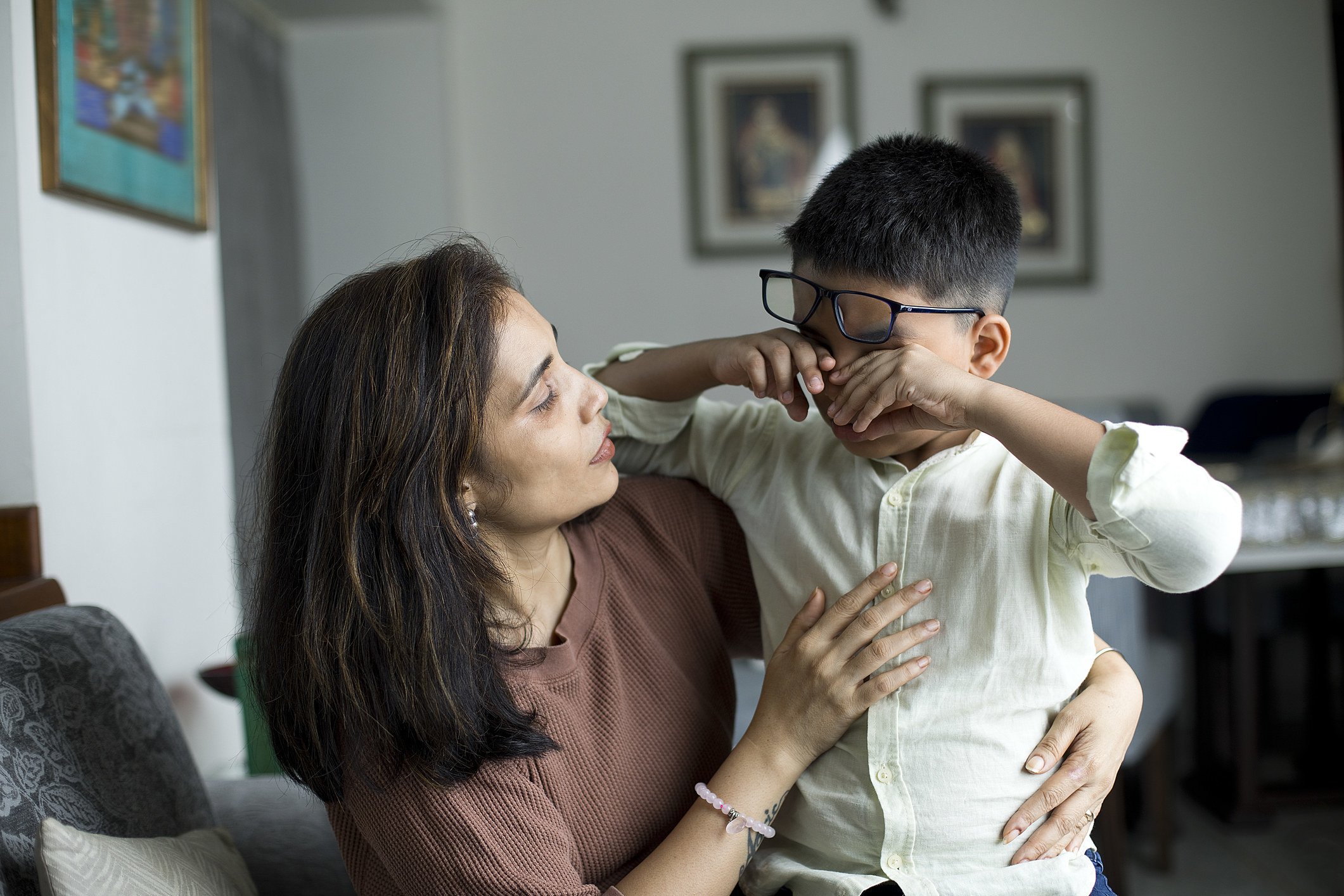 A mother calming a crying son