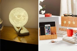 on left, moon-shaped illuminated lamp under hand sculpture. on right, bamboo charging station with iPhone and cables