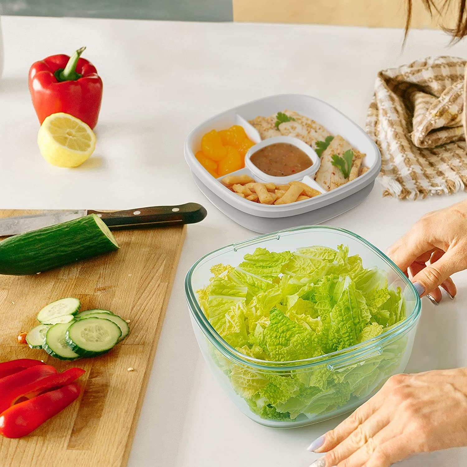 person making a salad with the container storing different ingredients