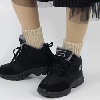 Model wearing the socks in beige while wearing low cut boots