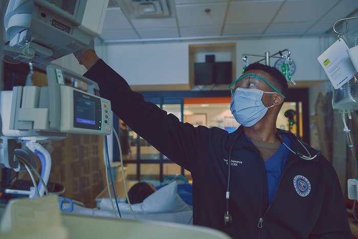 nurse looking at computers in hospital room